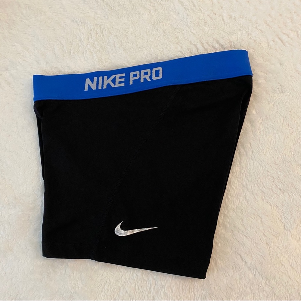 black nike pros with blue band